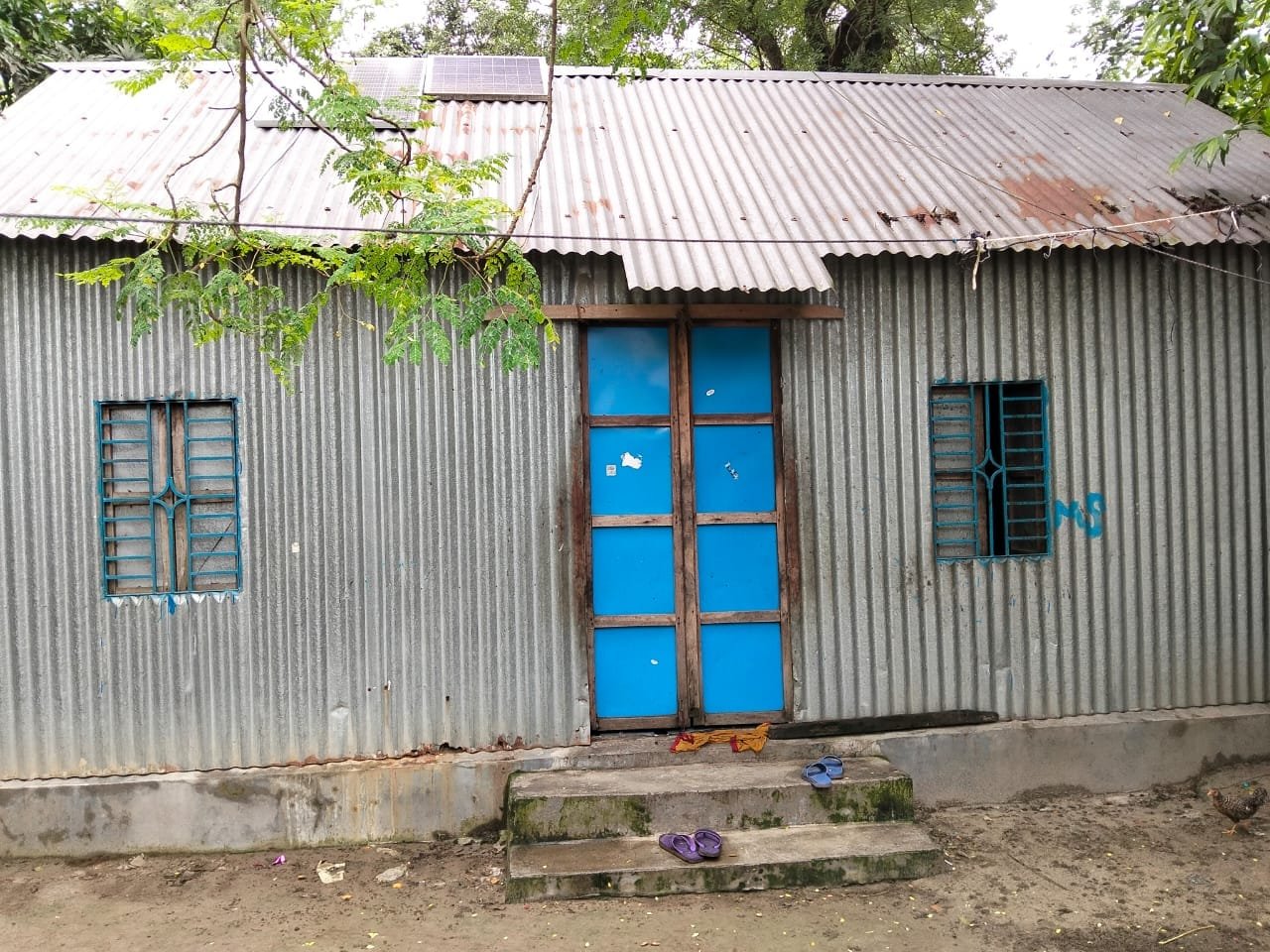 Tin house, blue door and windows.
